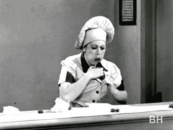 "Lucy on the chocolate factory line, face stuffed with chocolate as she shoves more into her clothes."