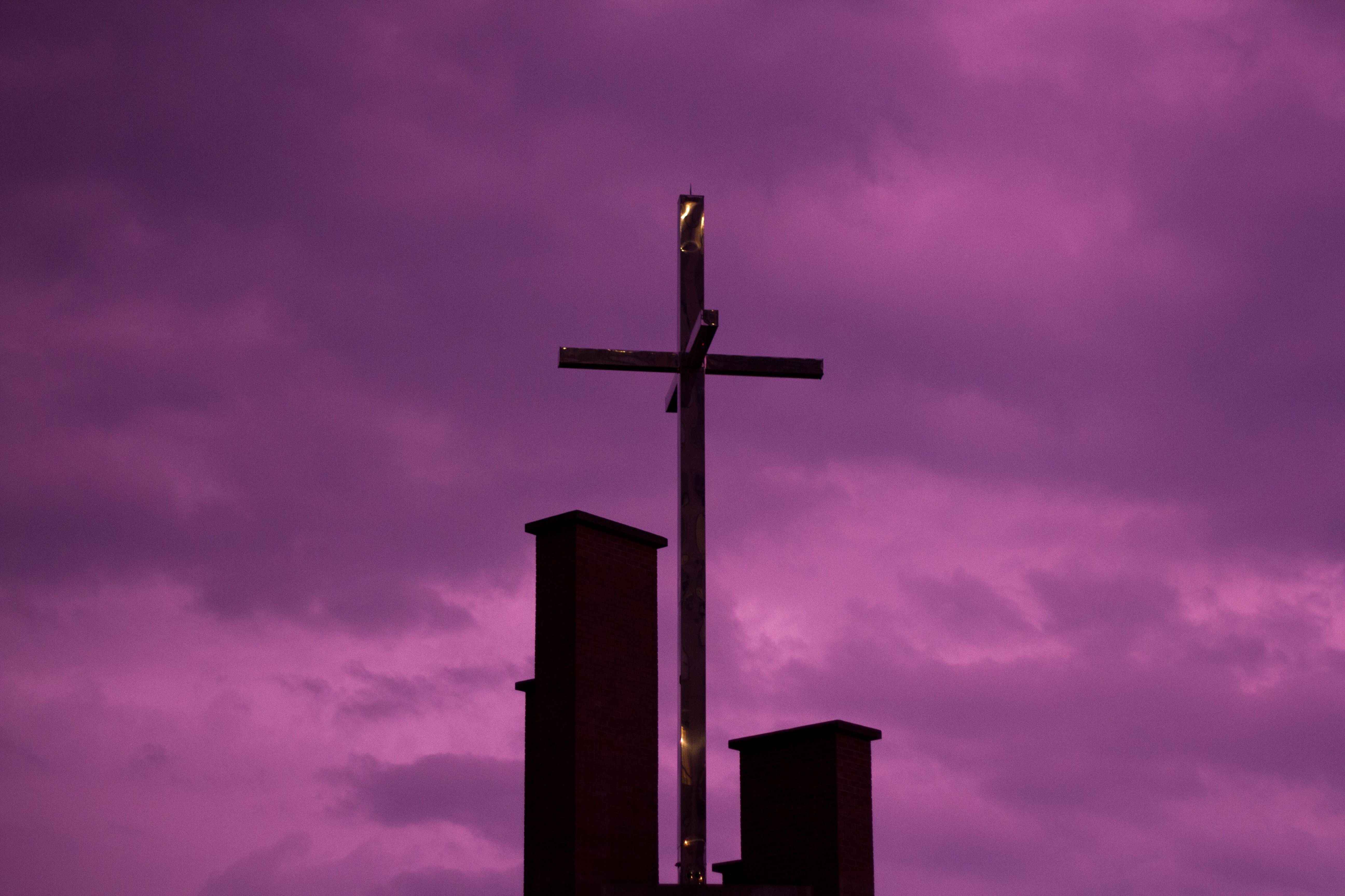 3-dimensional cross from church in front of purple stormy sky